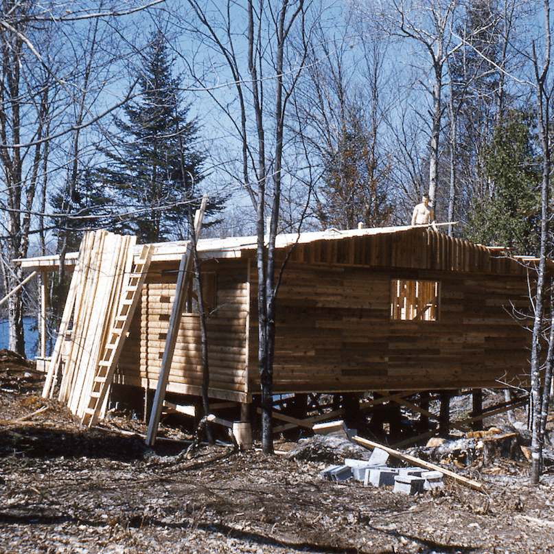 Rolf on the roof of a cottage under construction